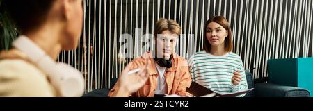 Colleagues engaged in a fruitful discussion at a stylish hotel lounge while on a trip. Stock Photo