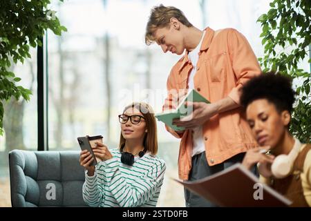 A group of colleagues engages in collaborative tasks in a hotel lounge, sparking creativity. Stock Photo