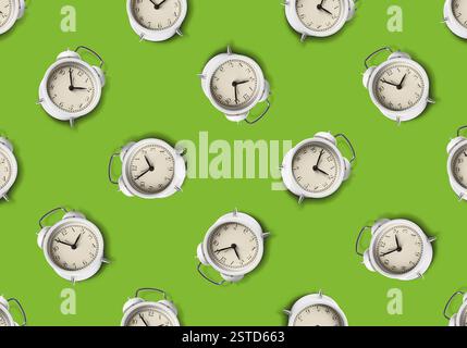 Pattern of white alarm clocks on light green background Stock Photo