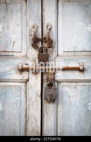 Two padlocks on the old door Stock Photo