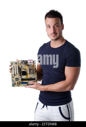 Smiling young man holding and showing computer motherboard Stock Photo
