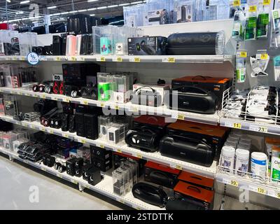 Lviv, Ukraine - February 16, 2025: Various speakers and electronic devices neatly arranged on a retail store's shelves Stock Photo