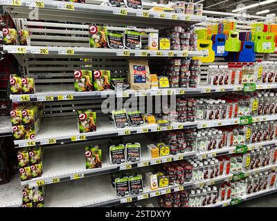 Lviv, Ukraine - February 16, 2025: Grocery store shelves showcasing fire accessories and charcoal supplies for grilling Stock Photo