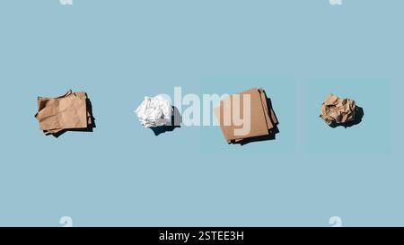 Four different crumpled paper items are laid out on a solid blue background, presenting contrast and simplicity. Stock Photo
