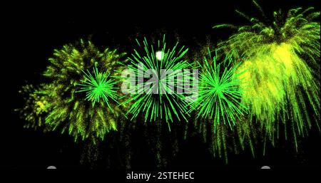 Green fireworks image bursting against black background Stock Photo