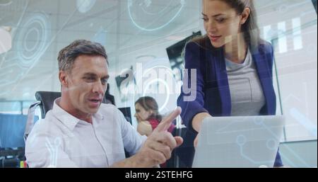 Analyzing data on laptop, business people with holographic charts image over office Stock Photo