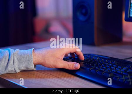 Close up view of man's hand typing on the PC's keyboard. Stock Photo