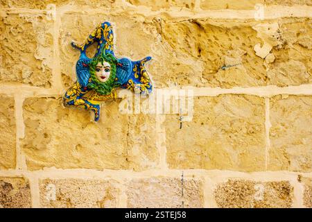 Traditional Sicilian Trinacria Plaque on Rustic Brick Wall Stock Photo