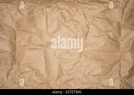 Crumpled brown kraft paper texture background. Stock Photo