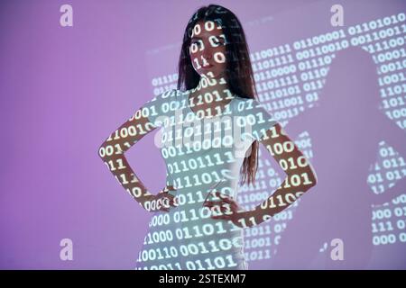 Binary machine code. Beautiful young woman is in projector neon lights in the studio. Stock Photo