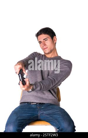 Attractive young man using joystick or joypad for videogames Stock Photo