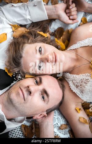 Wedding couple lying under a tree Stock Photo
