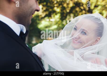 The bride and groom posing together at camera Stock Photo