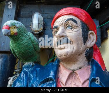 Isle of Wight, UK - May 1st 2023: A pirate and parrot outside The Spyglass Inn public house, located on Ventnor Bay on the Isle of Wight, UK. Stock Photo