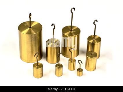 Brass hooked weights scientific laboratory measuring equipment isolated on white background table. Stock Photo