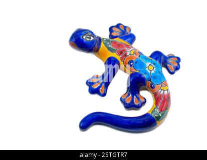 Mexican ceramic pottery of a salamander, gecko or lizard indoor outdoor wall art painted multi colored blue, red, yellow, orange with flower pattern d Stock Photo
