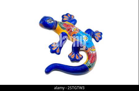 Mexican ceramic pottery of a salamander, gecko or lizard indoor outdoor wall art painted multi colored blue, red, yellow, orange with flower pattern d Stock Photo