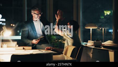 Night, programmer meeting and high five for feedback, success and overtime work for partnership. Business men, mentor and collaboration for web design Stock Photo
