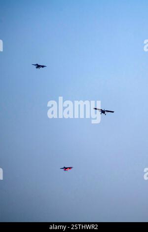 Propeller plane is flying on isolated blue sky Stock Photo