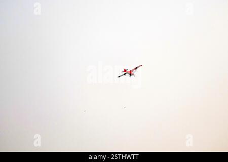 Propeller plane is flying on isolated white background Stock Photo