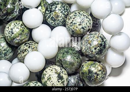 Delicate and charming white agate beads and green serpentine, ideal for jewelry, crafts, or decor. Close up photo, perfect for enhancing various creat Stock Photo