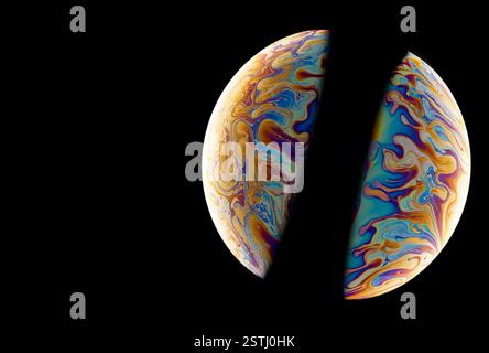 Two of colorful soap bubbles in the shape of ball on a black background. High resolution. Stock Photo