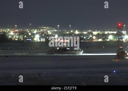 Toronto, Canada.18th February 2025. The wreckage of a Delta Air Lines-operated CRJ900 aircraft lays on the runway at Toronto Pearson International Airport on February 18, 2025 in Toronto, Canada. A Delta Air Lines flight from Minneapolis crashed, turned upside down and caught fire on the runway at Toronto Pearson International Airport while attempting to land on February 17. Credit: Yu Ruidong/China News Service/Ģ����ý Live News Stock Photo