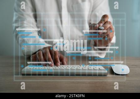 Project Management Organization A computer monitor and laptop are placed on a desk with a calendar on the laptop. Stock Photo