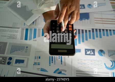 man hand using calculator finance budgeting and tax Financial cost calculation statistical data analysis Stock Photo