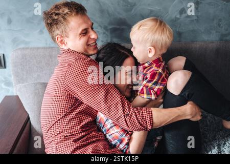 dad, mom and small son in the room on the couch Stock Photo - Alamy
