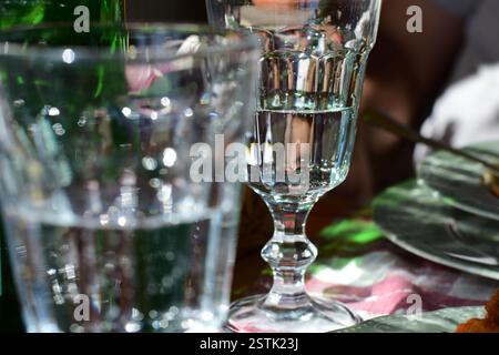 Closeup of crystal clear goblet glasses set on the restaurant table in the sunlight Stock Photo