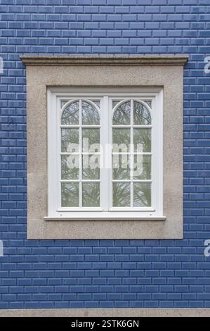 Vintage white window on ceramic wall of Portugal old Portuguese house wall, blue bricks texture Stock Photo