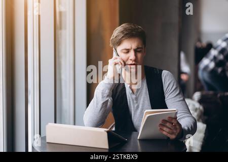 Young man with tablet pc computer at cafe Stock Photo
