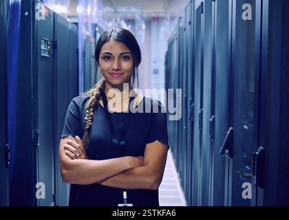 Portrait of smiling female technician in server room Stock Photo