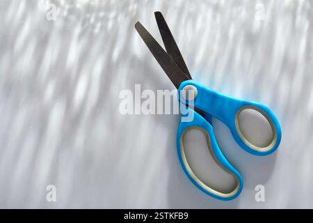 Blue children's scissors on white background Stock Photo