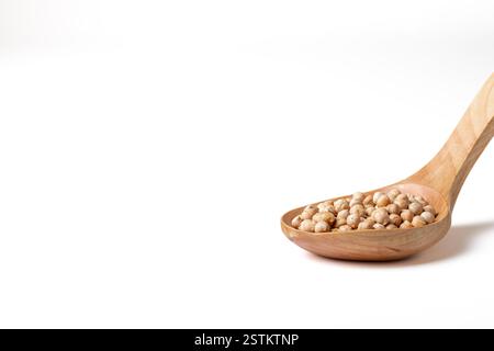 Group of lentils on a wooden spoon on a white background Stock Photo