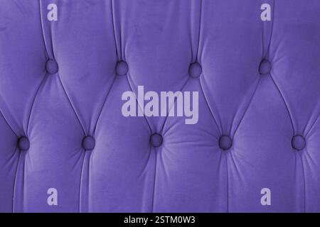 Capitone, diamond checkered soft fabric textile decorative background with buttons. Classic retro Chesterfield style, luxurious upholstery purple text Stock Photo