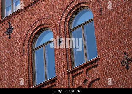 Two windows on a brick red wall Stock Photo