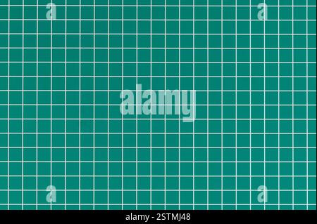 Vibrant green crafting surface featuring grid pattern, ideal for cutting materials and creating designs with accuracy. Stock Photo