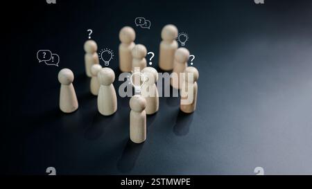 Questions and brainstorming, Wooden doll as person who have questions and need help solving the problems among crowd people, Business marketing and Cr Stock Photo