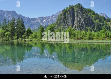 Almsee clear mountain lake reflecting mountains and green forests in Upper Austria. Stock Photo