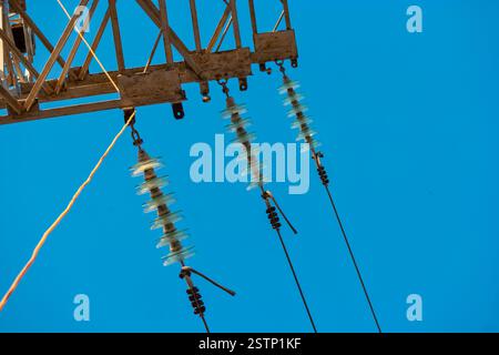Power tower detail with three row od glass insulators and the wires in ...