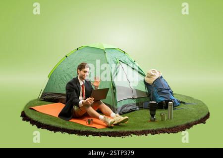 Composite image of businessman sitting outside tent on floating island, waving at laptop during video call against gradient green background. Stock Photo
