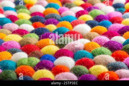 Multicolored felt ball rug detail Stock Photo