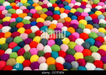 Multicolored felt ball rug detail Stock Photo