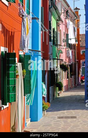 Colourful Burano Houses With Laundry in Narrow Street Stock Photo