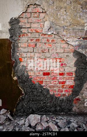 Demolished plaster over worn wall with new cement plaster Stock Photo
