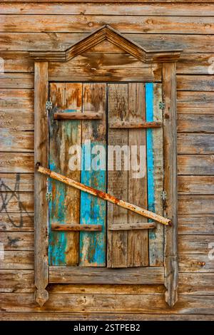 Weathered wooden window in slums Stock Photo