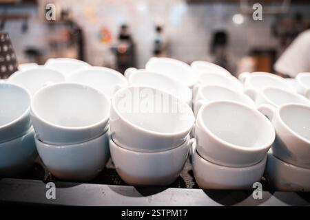 Stack of small ceramic cups on shelf. Stock Photo