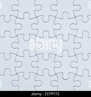 Close-up white jigsaw puzzle background surface with copy space Stock Photo